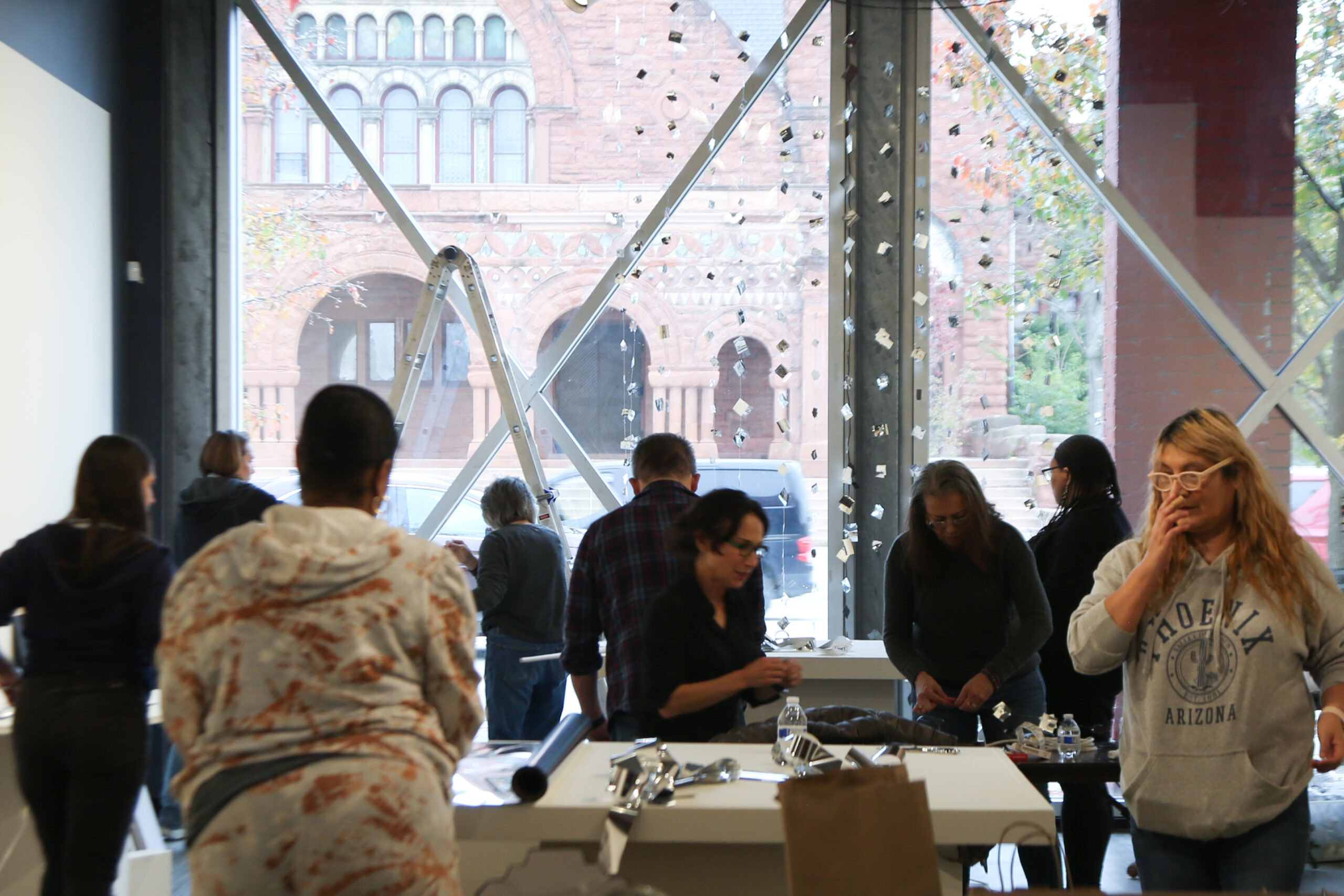 Group of volunteers decorating for DAM’s annual Art for the Holidays exhibition (2024).