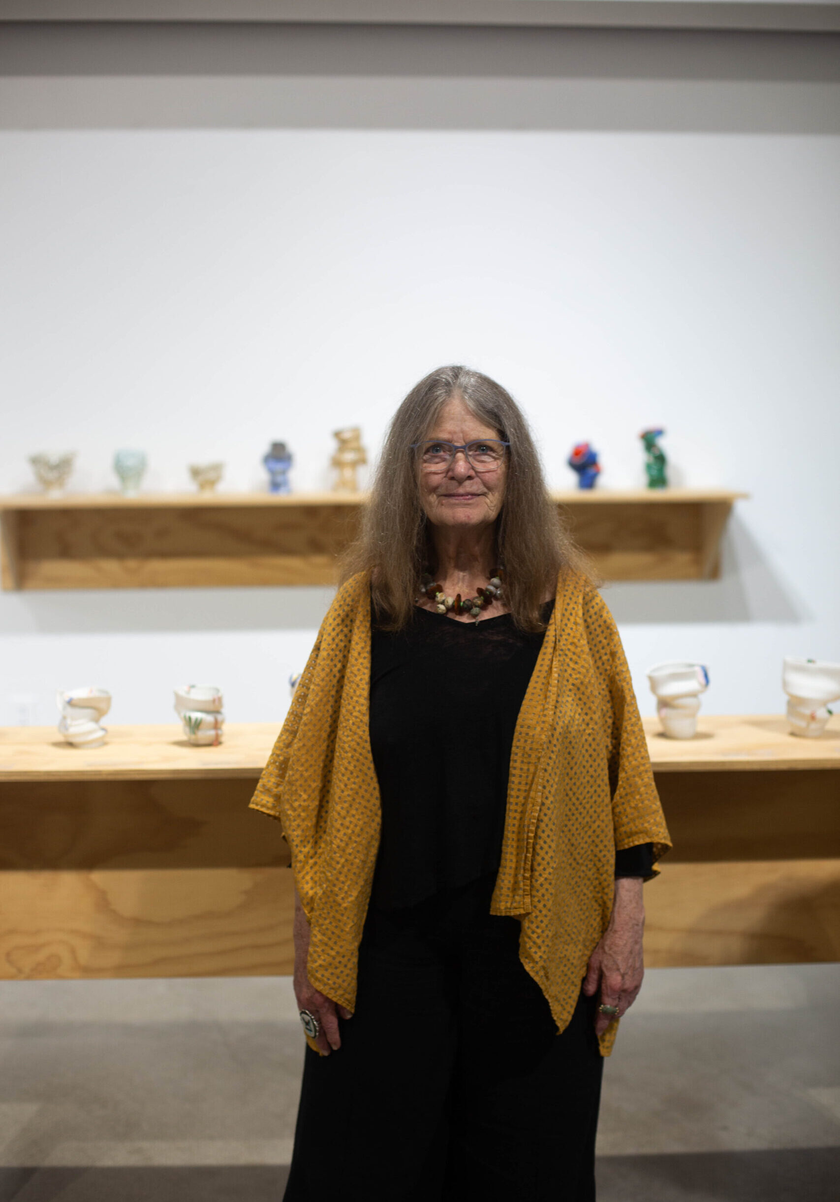 Headshot of Deb King in front of ceramic vases.